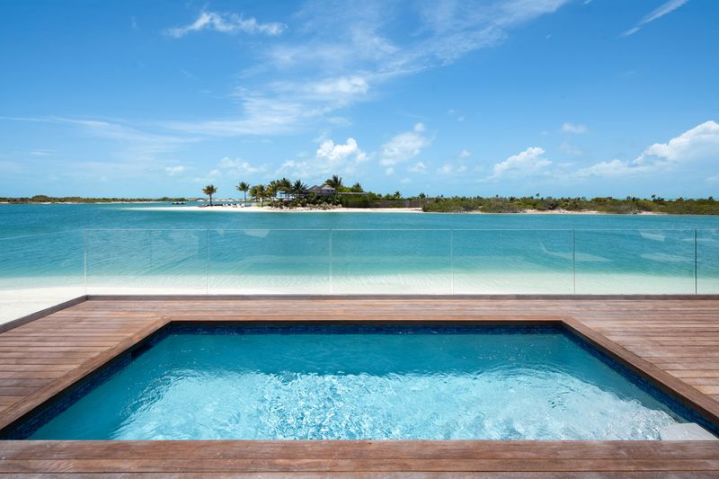 a pool on a deck overlooking a body of water