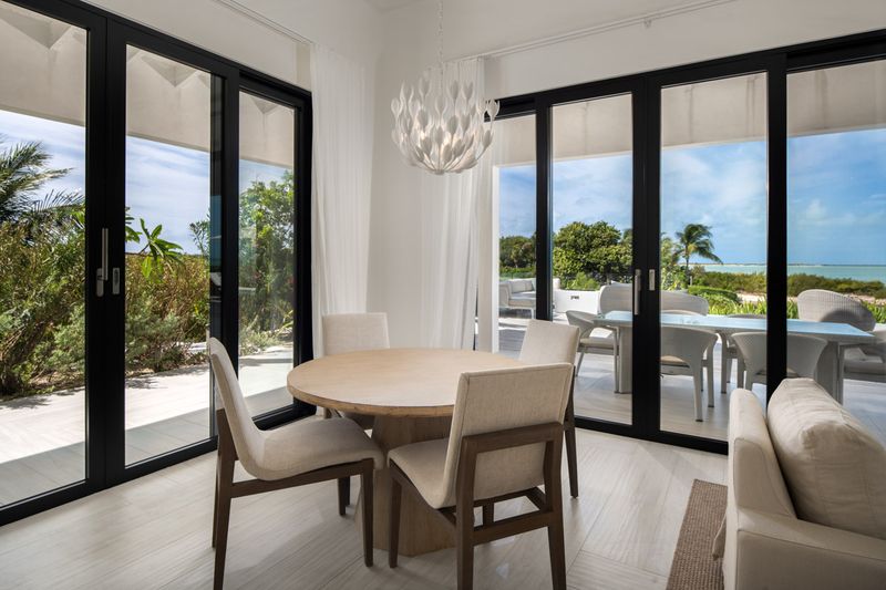 a dining room with a table and chairs