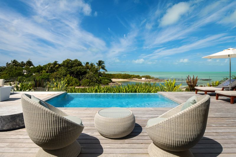 a pool with chairs and a table
