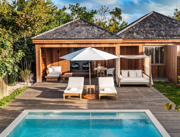 a pool and lounge chairs on a deck