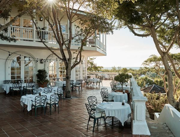 a patio with tables and chairs