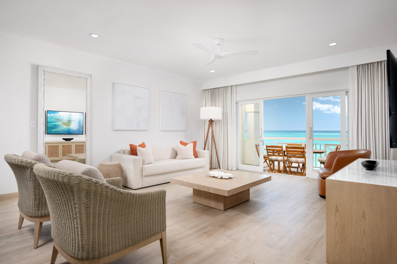 a living room with a view of the ocean