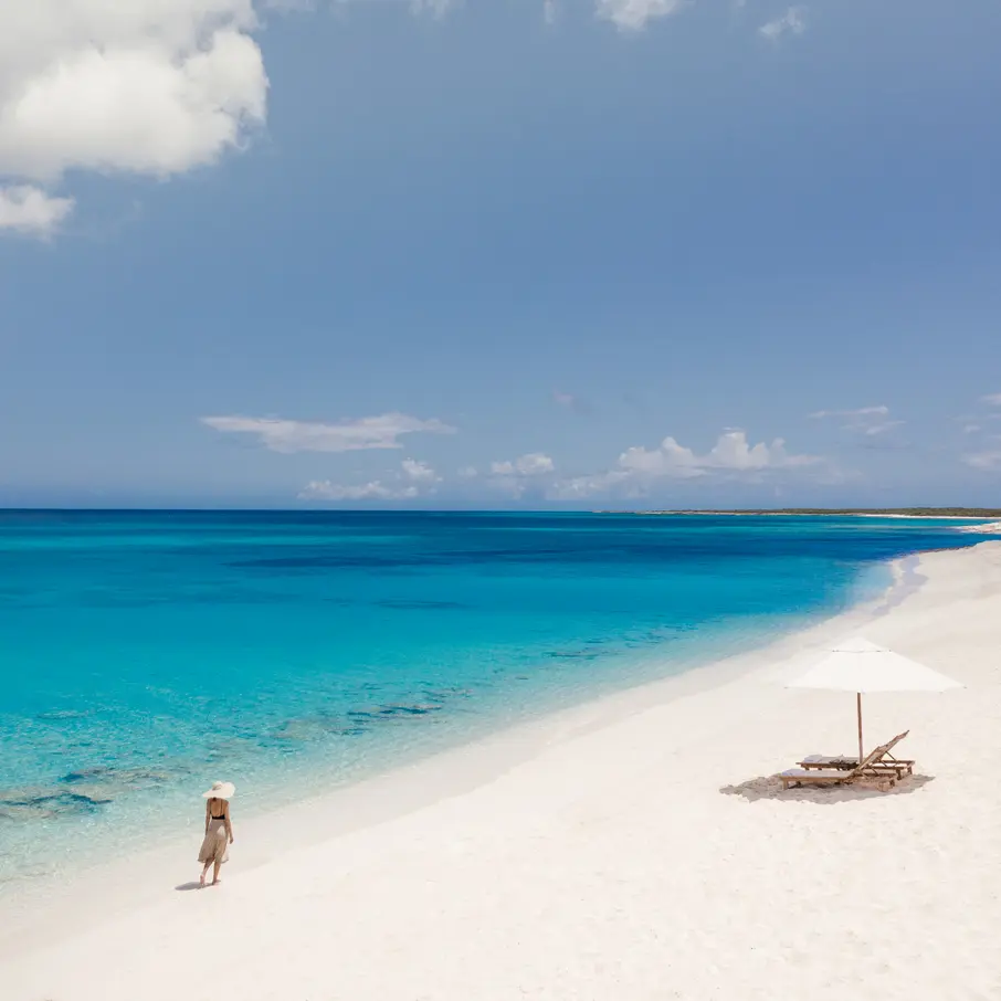 a woman walking on a beach