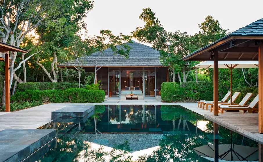 a pool with a building and trees around it