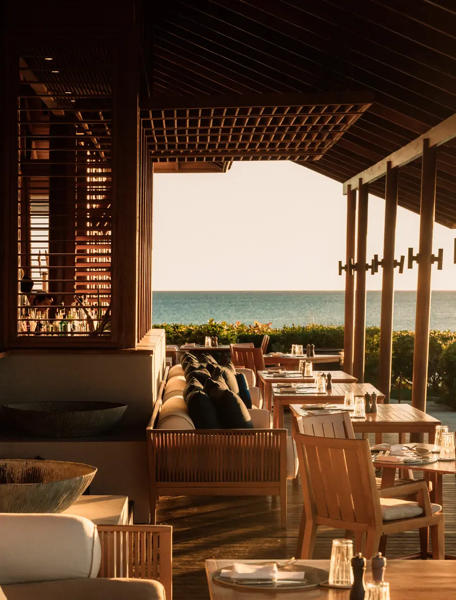 a restaurant with tables and chairs on a deck