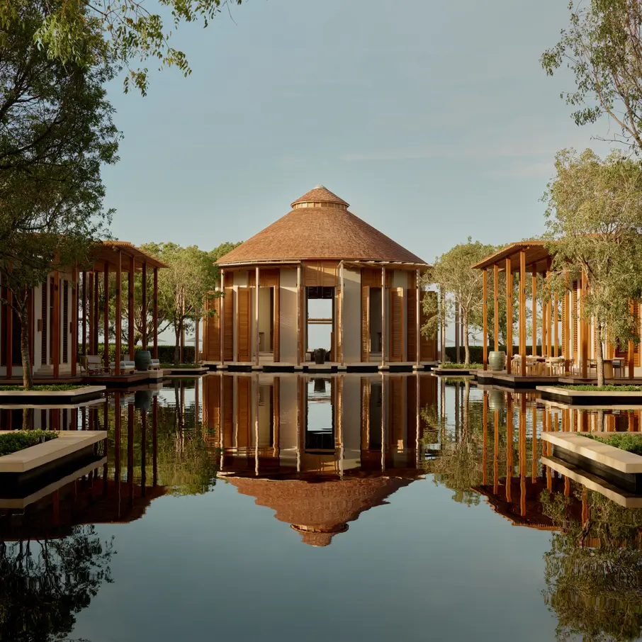a gazebo surrounded by trees and water