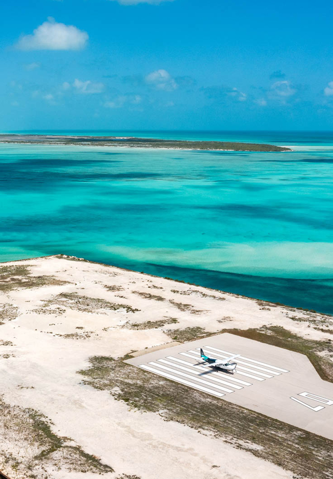an airplane on a runway near a body of water