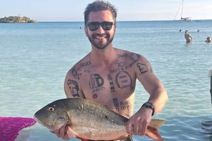 a man holding a fish