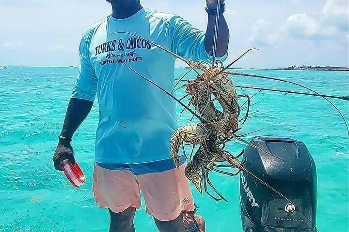 a man holding a lobster