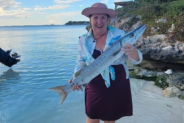 a woman holding a fish