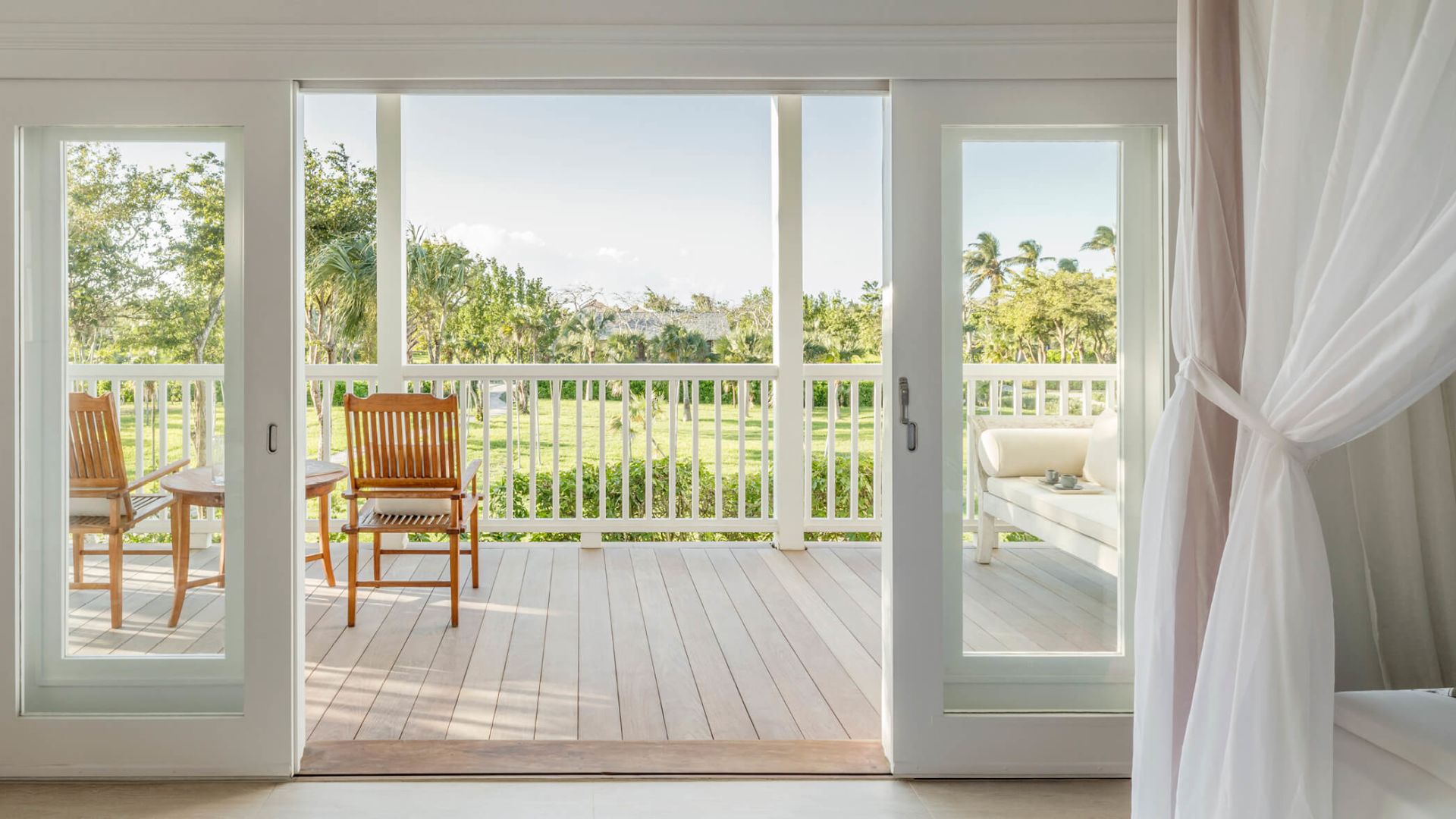 a patio with a deck and a table and chairs