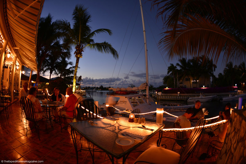 a group of people sitting at a table with lights on it