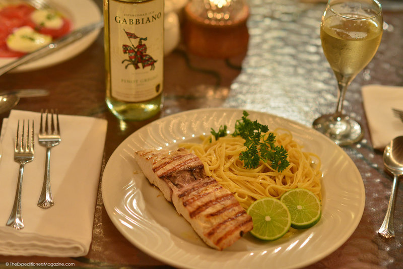 a plate of food and a wine bottle