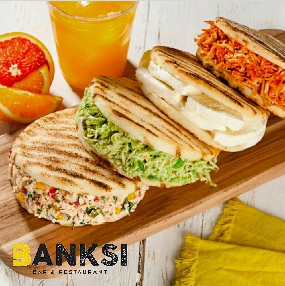 a plate of sandwiches and orange juice