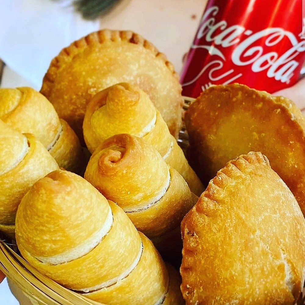 a basket of pastries and a soda