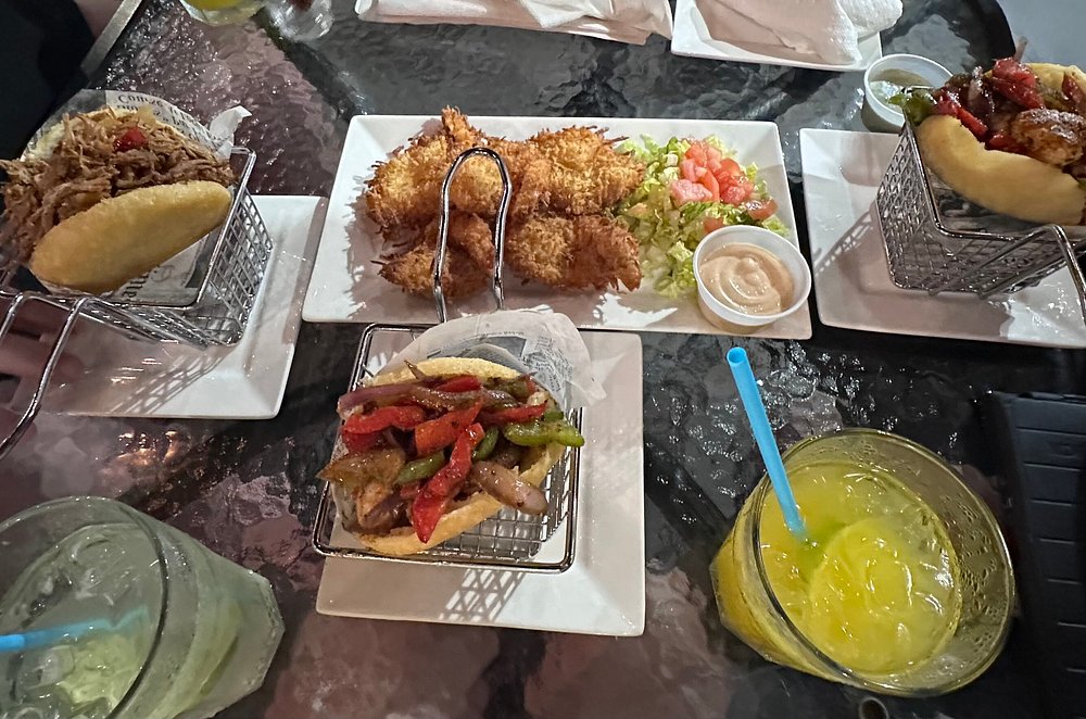 a table with plates of food and drinks