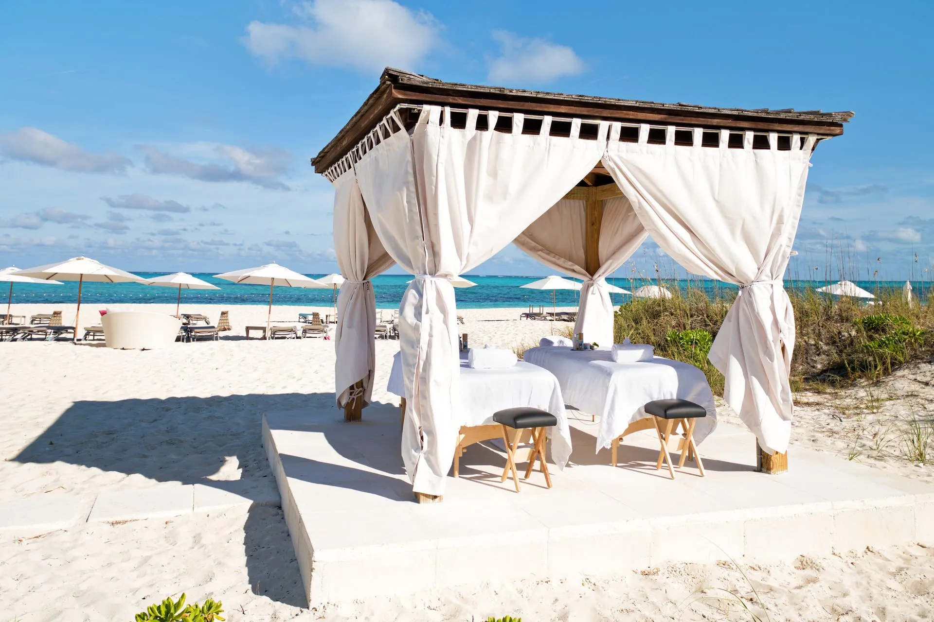 a table and chairs on a beach