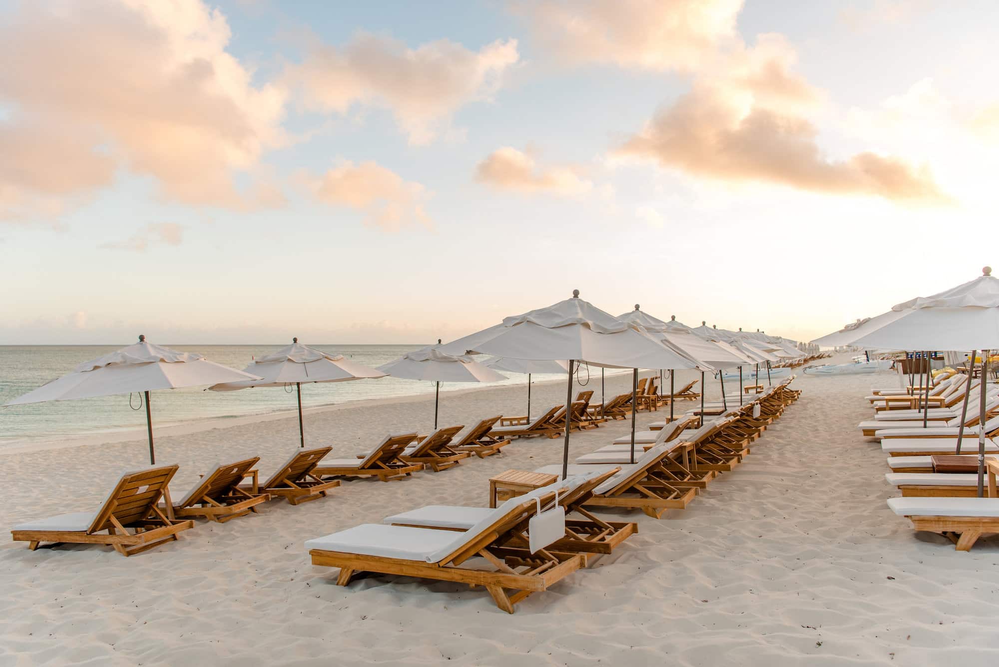 a beach with chairs and umbrellas