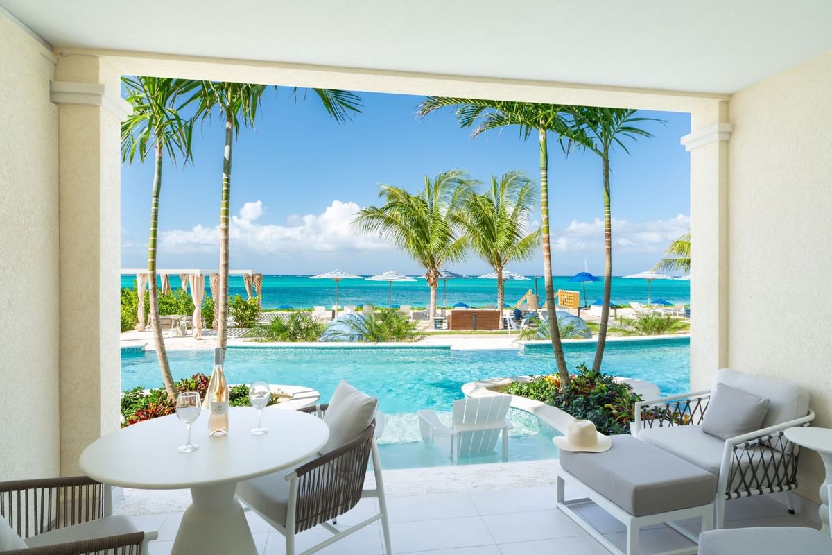 a pool with palm trees and chairs