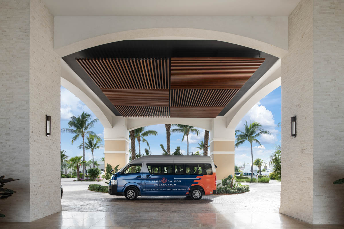 a blue and orange van parked under a white and brown ceiling