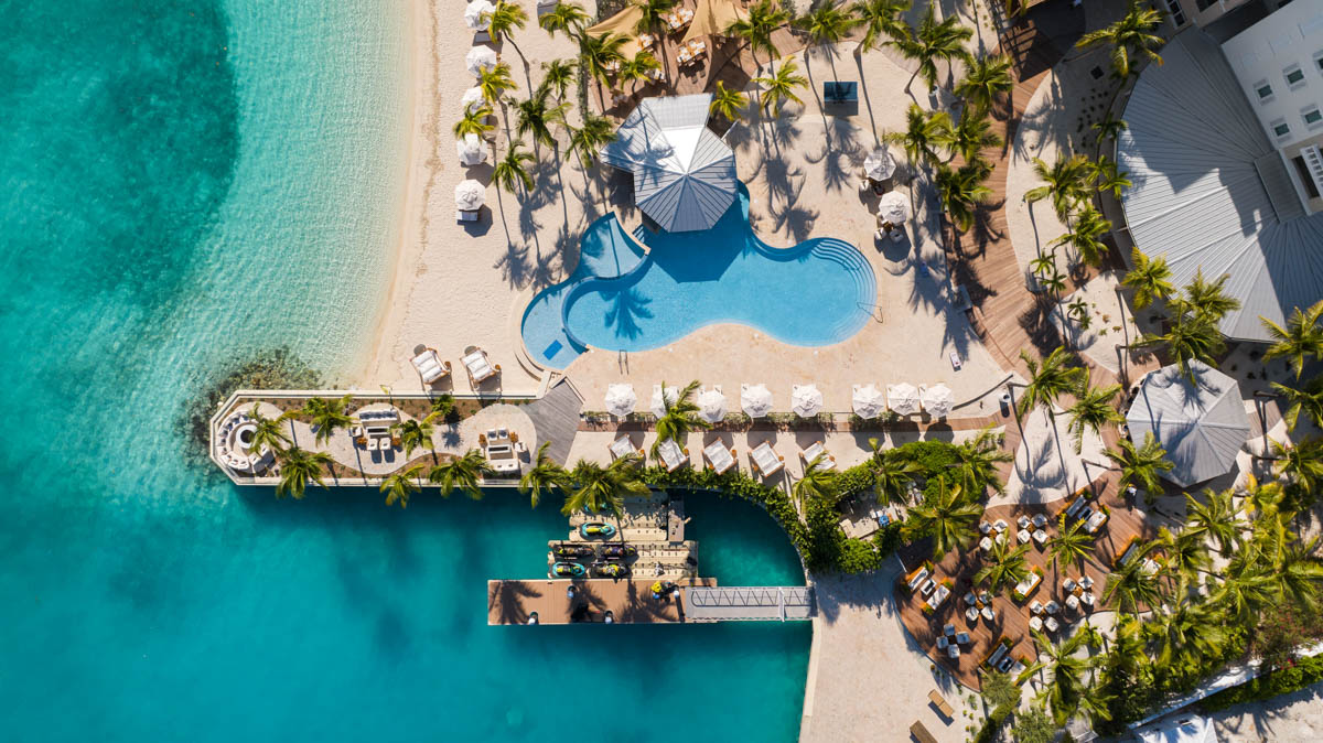 a swimming pool and a dock on a beach