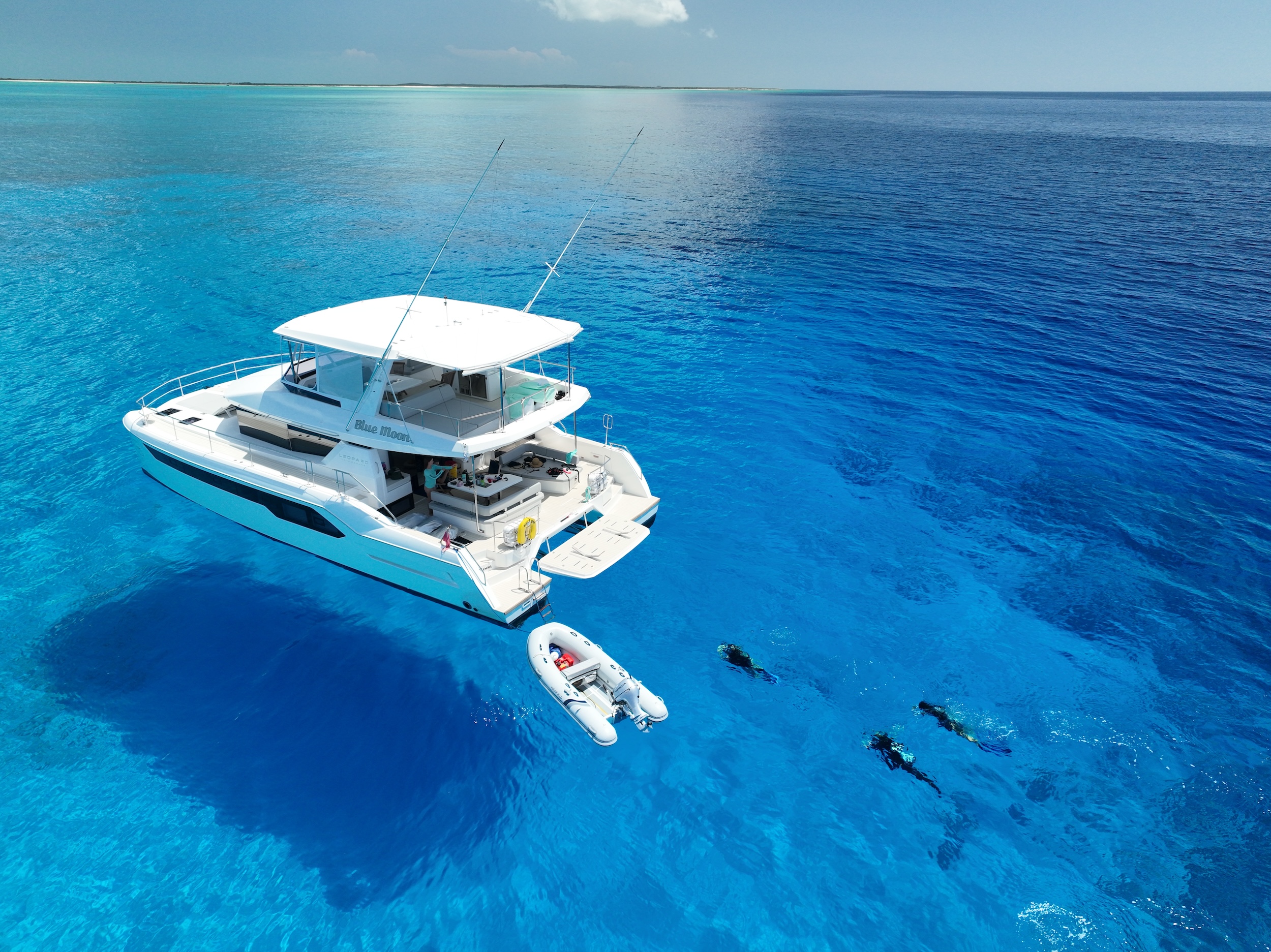 a boat in the water with scuba divers