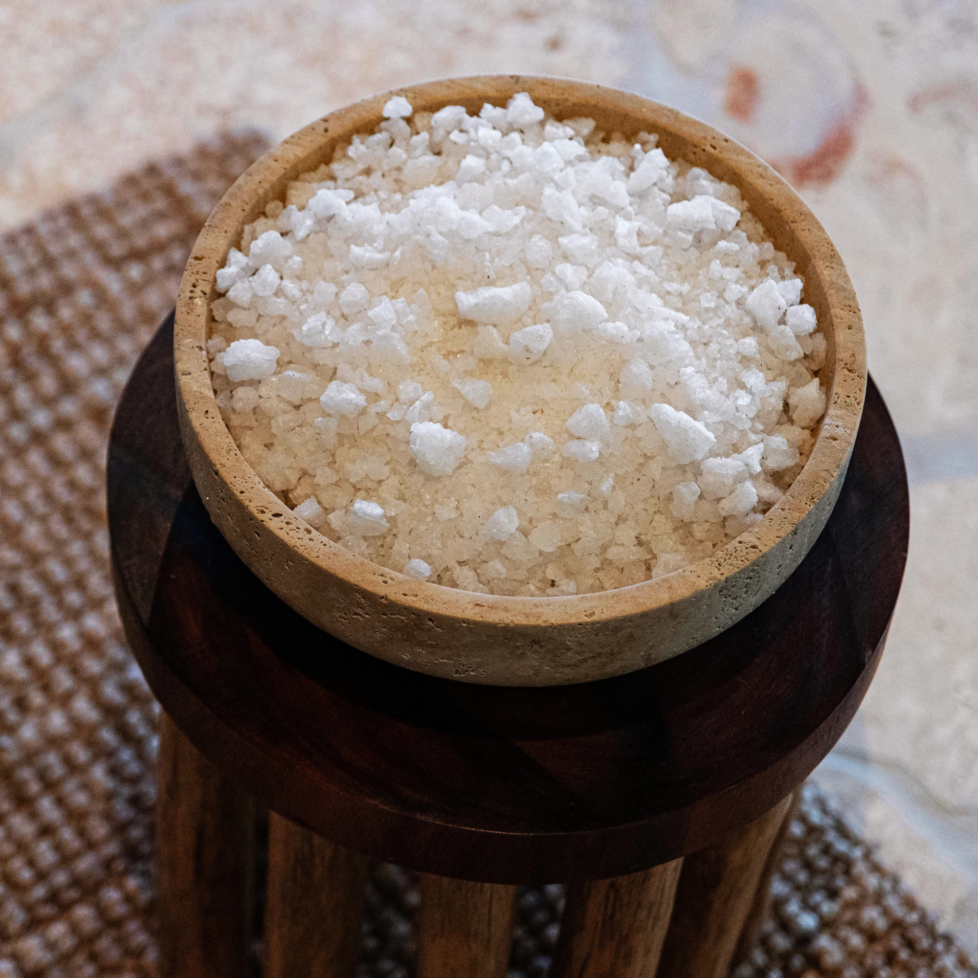 a bowl of salt on a stool