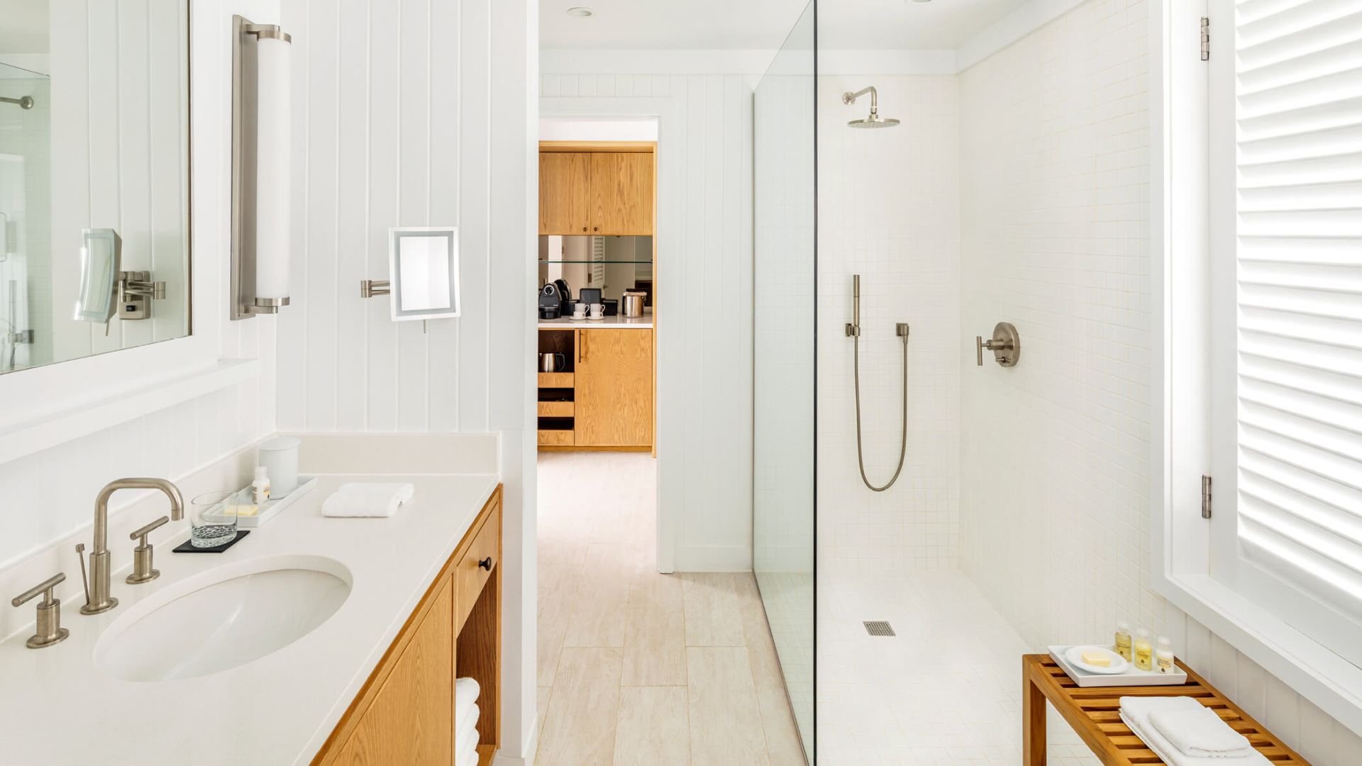 a bathroom with a glass shower and sink