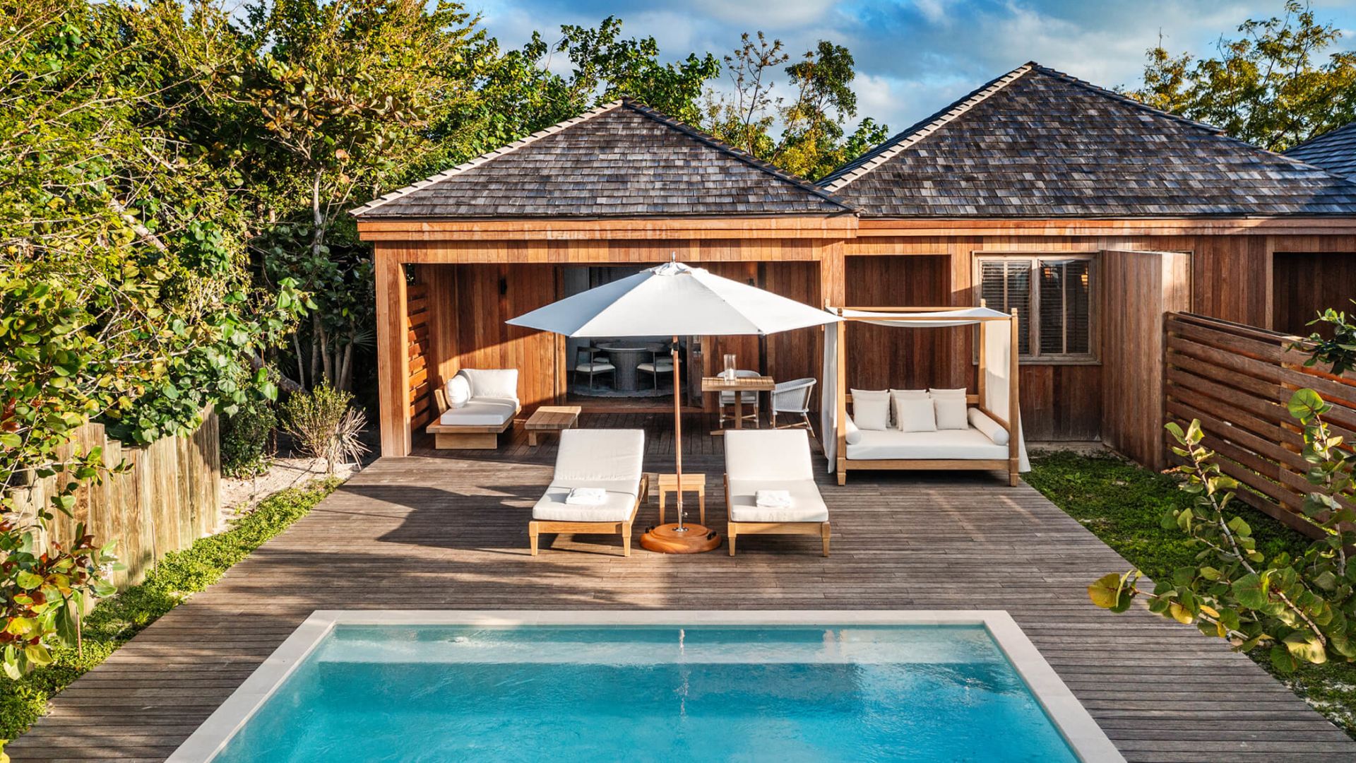 a pool and lounge chairs on a deck