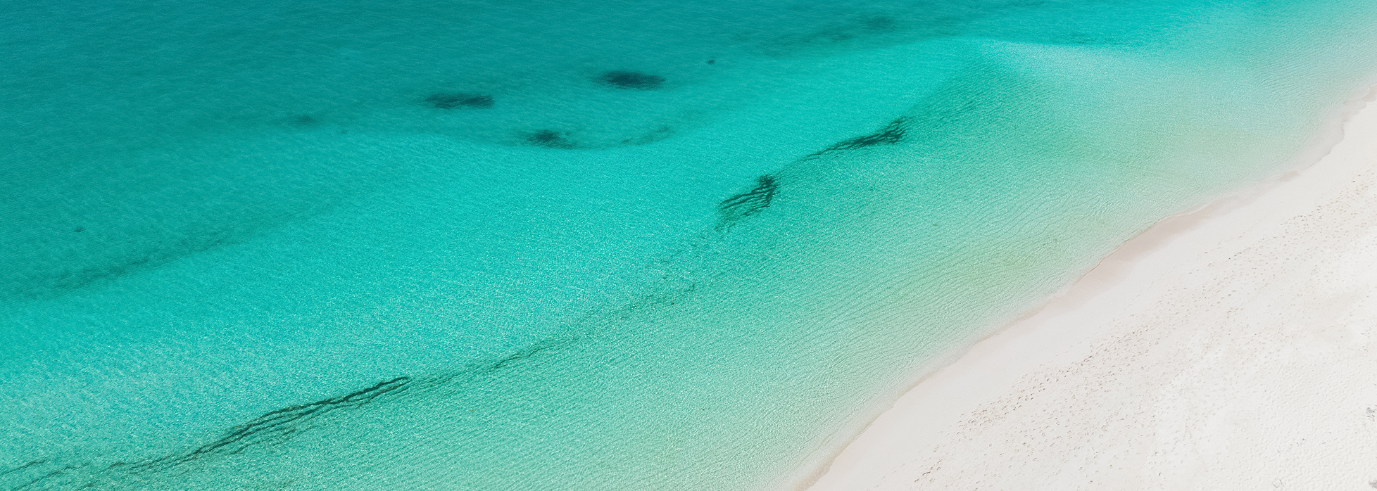 a beach with clear blue water