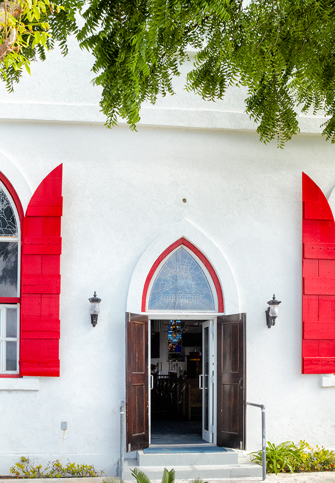 a white building with red shutters