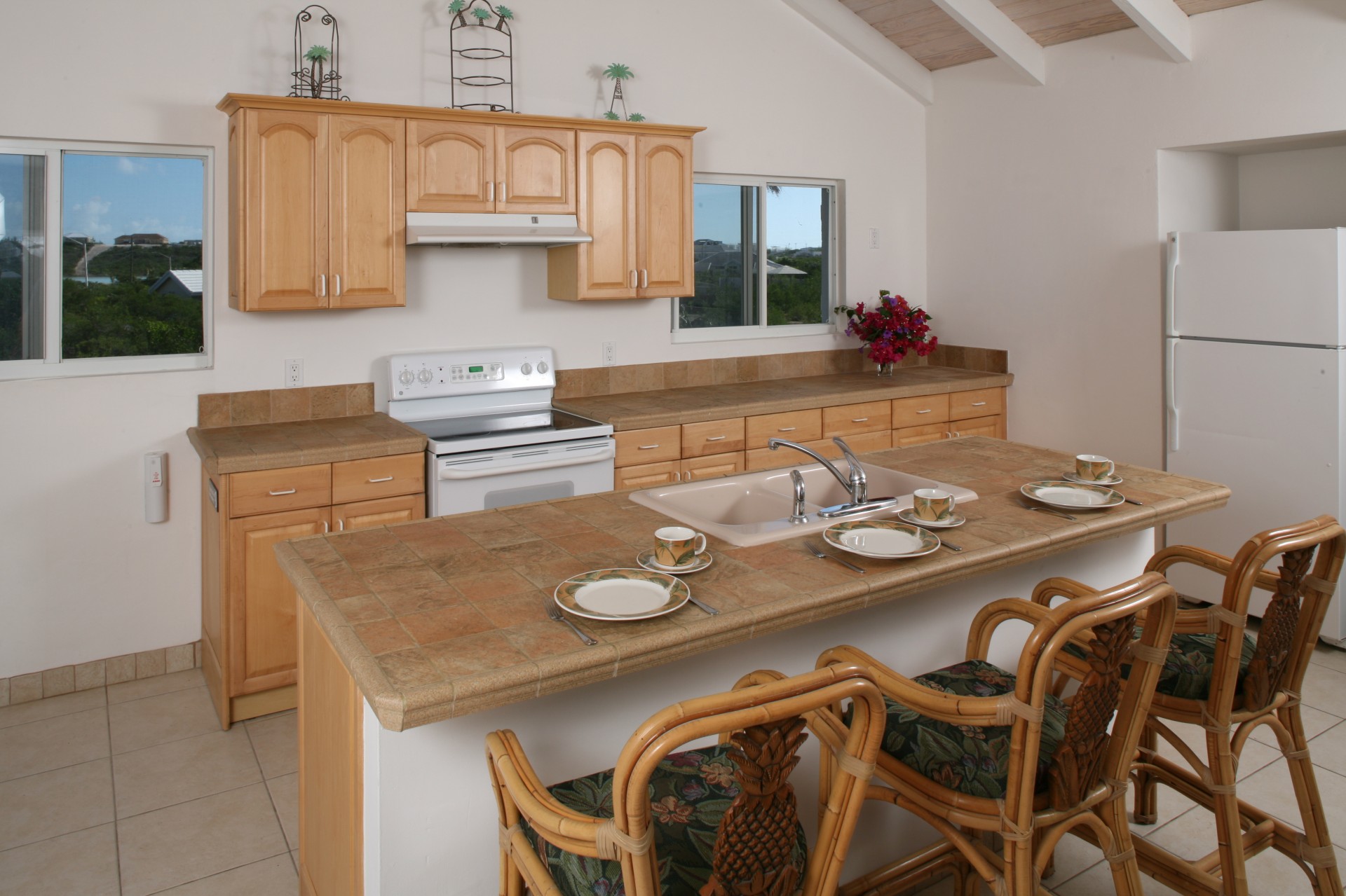 a kitchen with a large island and chairs