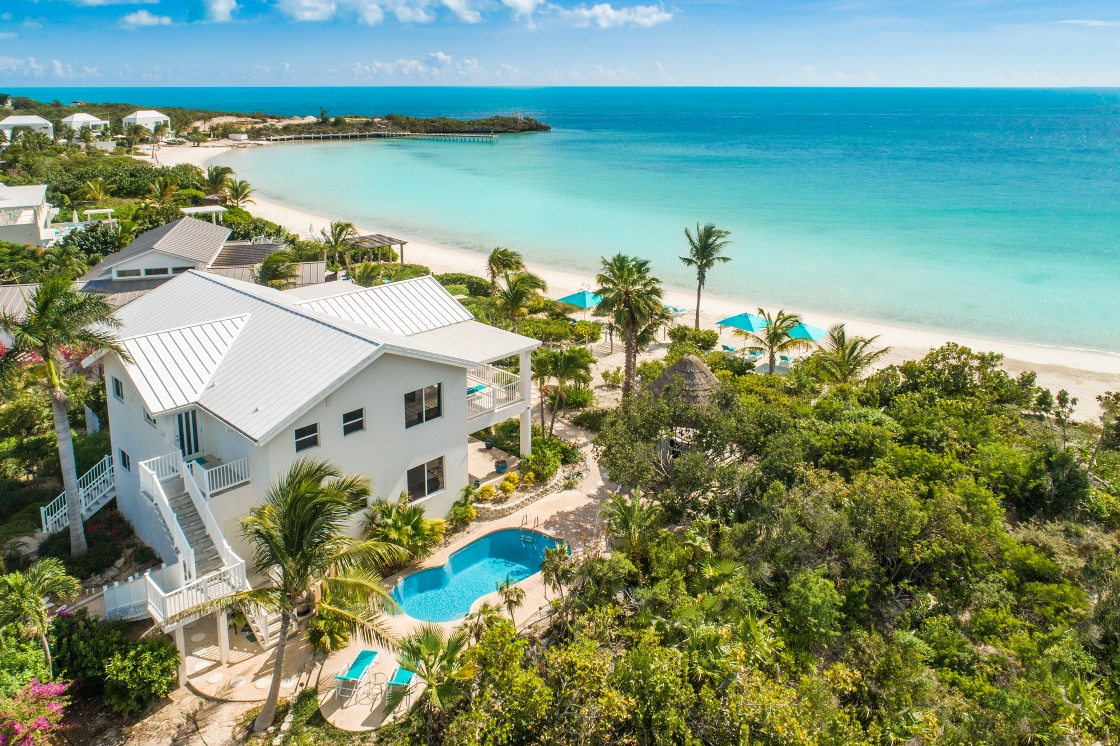 a beach with a pool and houses