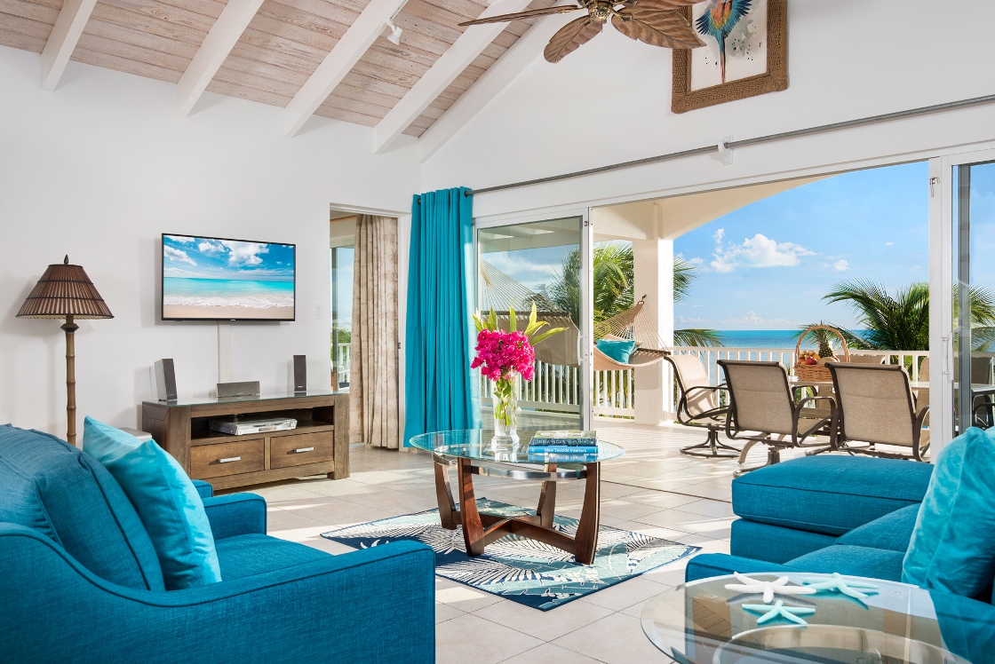 a living room with blue furniture and a television