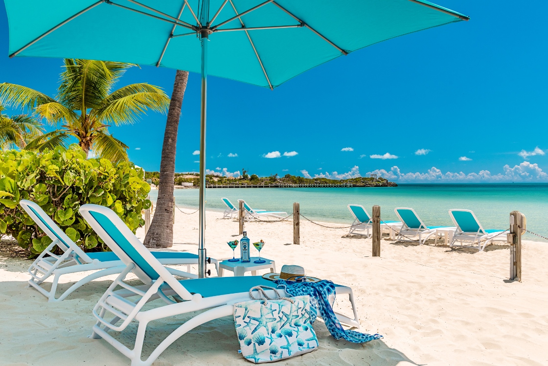 a beach with chairs and umbrellas