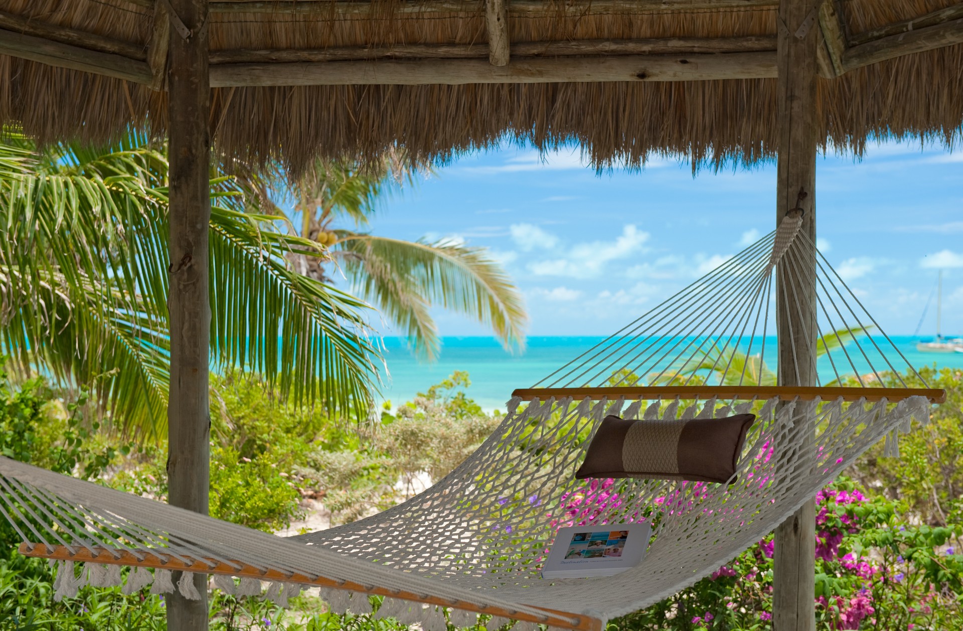 a hammock with a pillow and a book on it