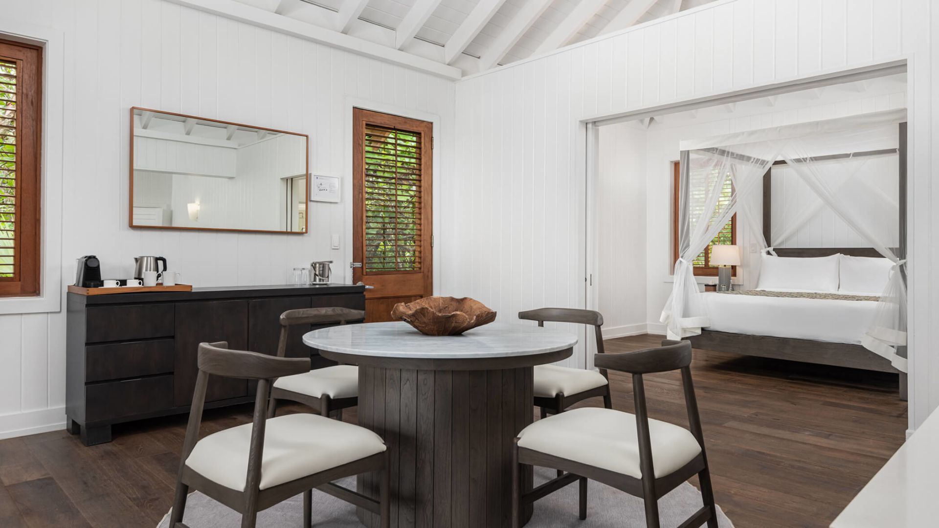 a room with a round table and chairs