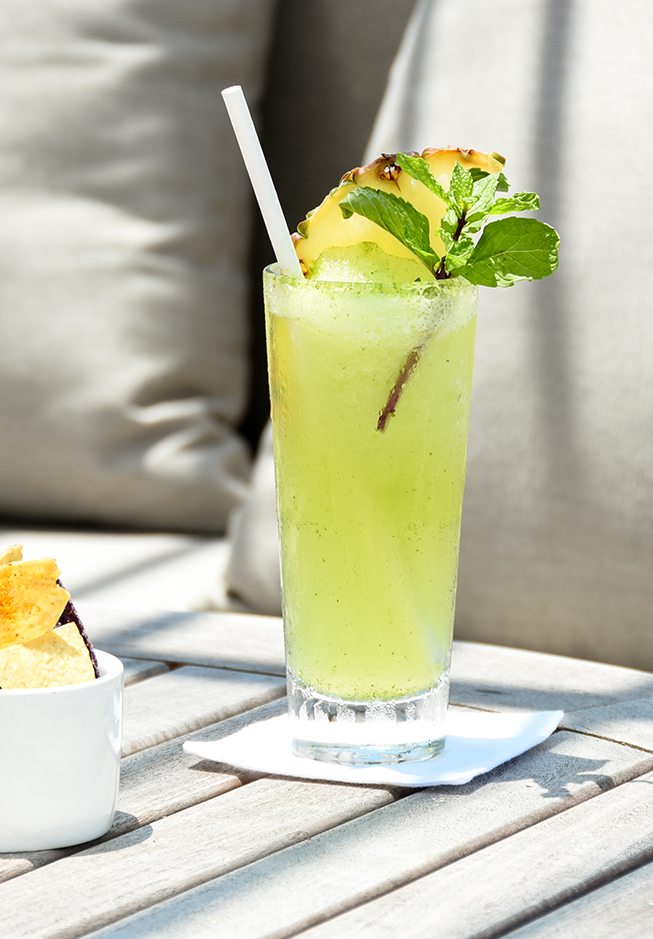 a glass with a drink and a straw on a table