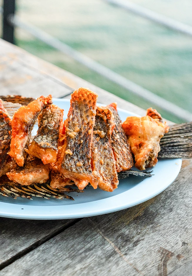 a plate of fried fish on a table