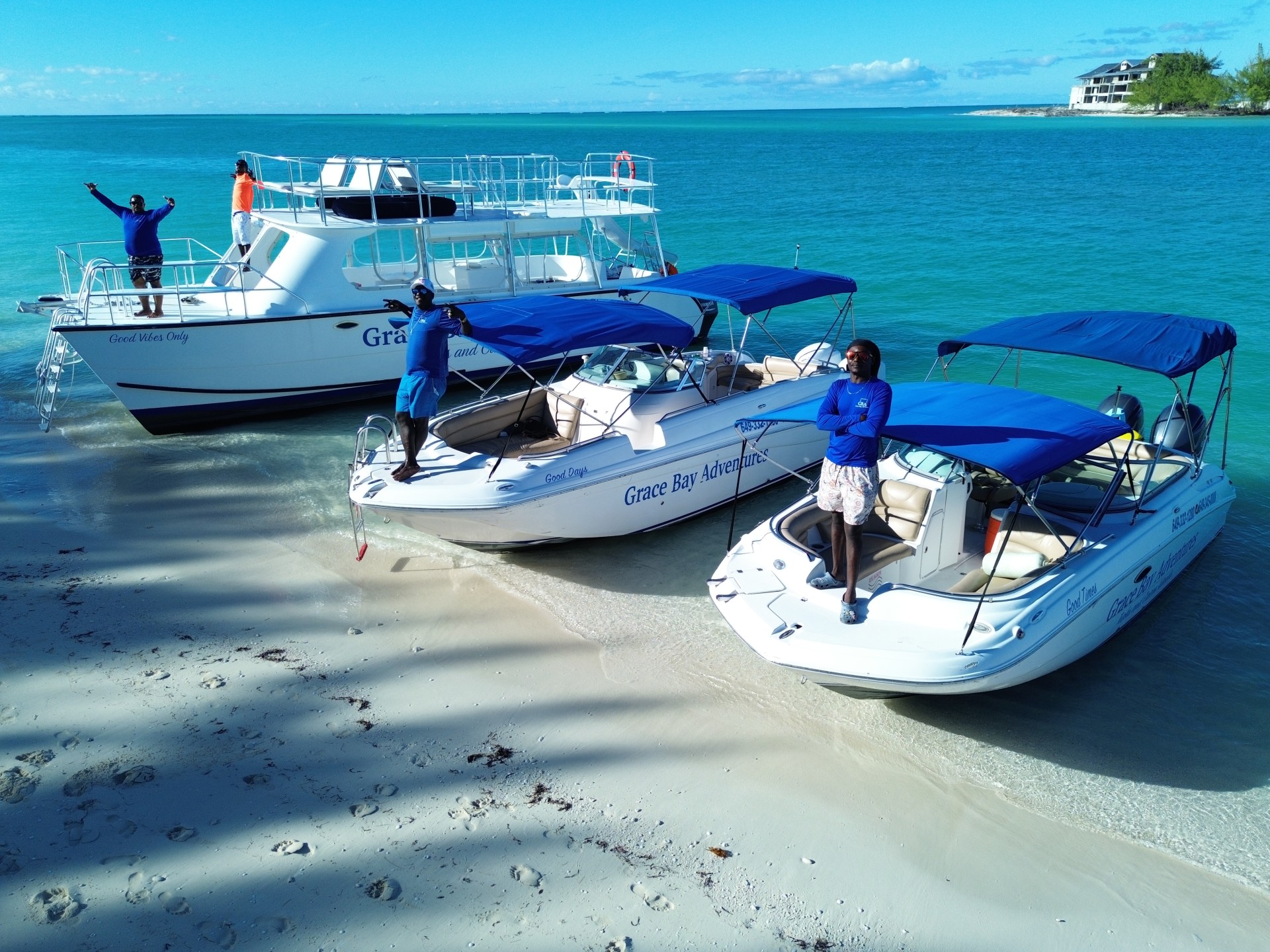 a group of people standing on a beach with boats