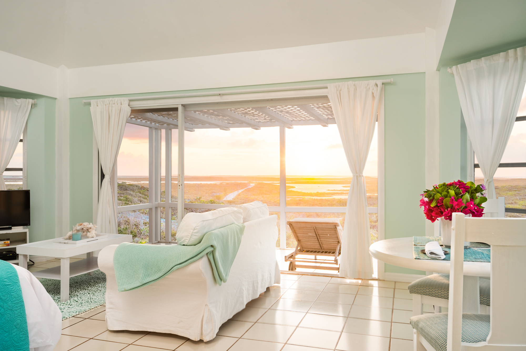 a living room with a view of the ocean