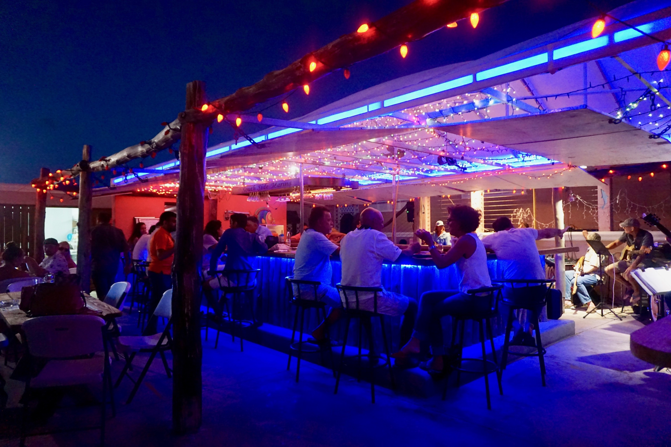 a group of people sitting at a bar