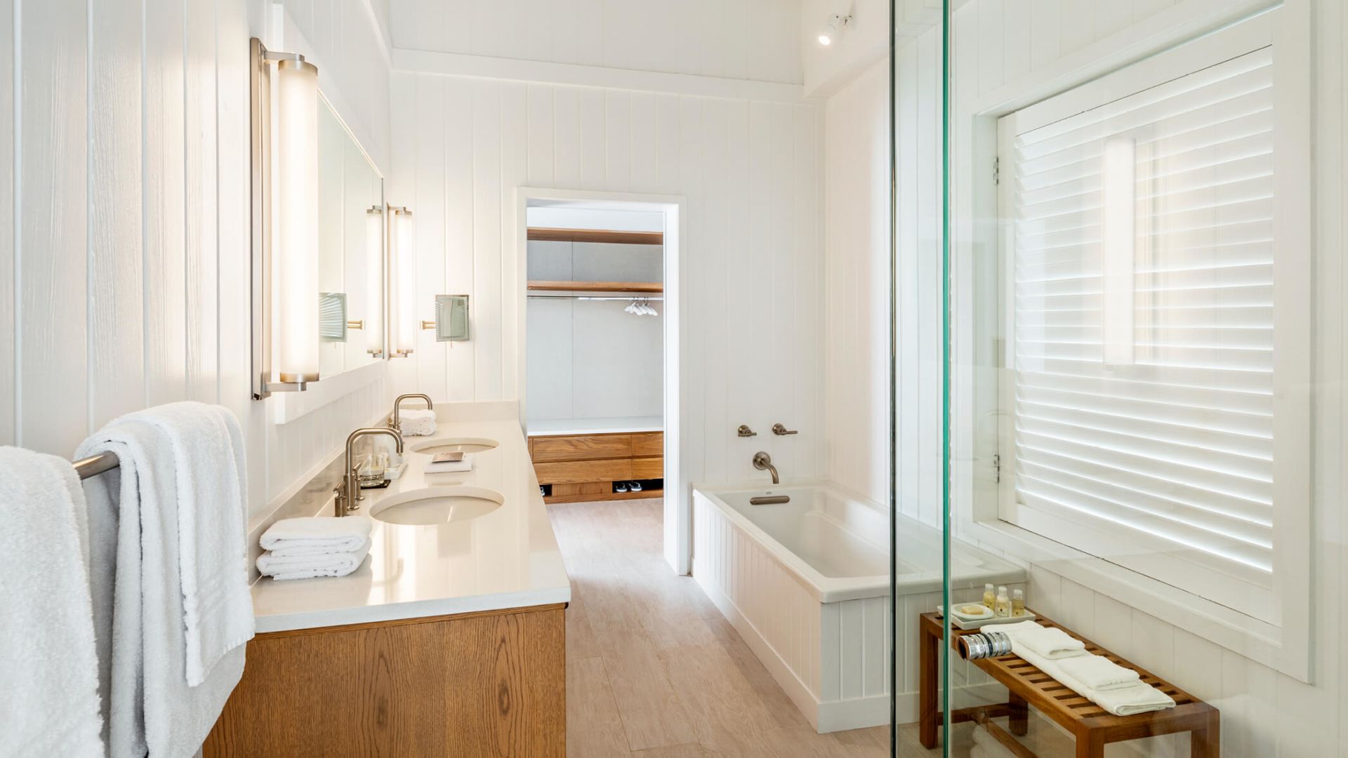 a bathroom with a glass shower and sink