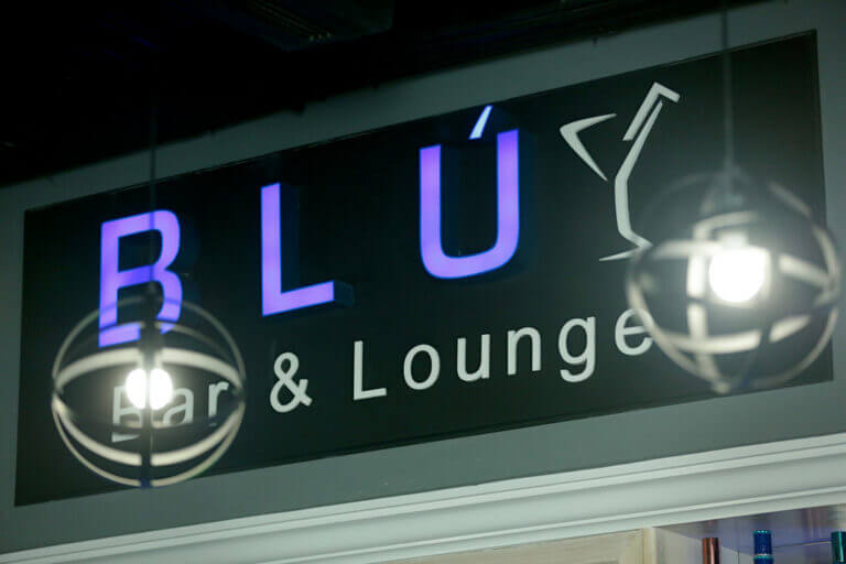 a sign with a bar and lounge logo