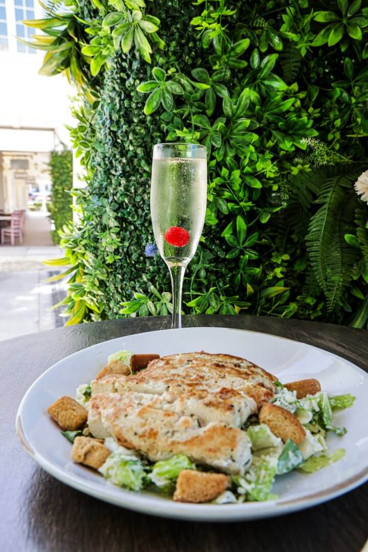 a plate of food and a glass of champagne