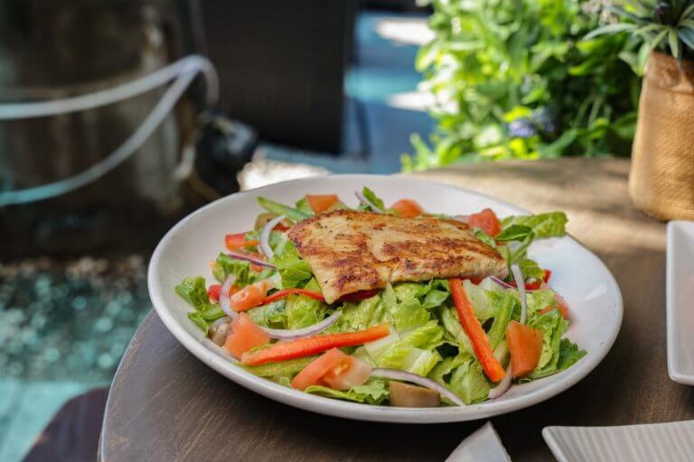 a plate of salad with meat and vegetables