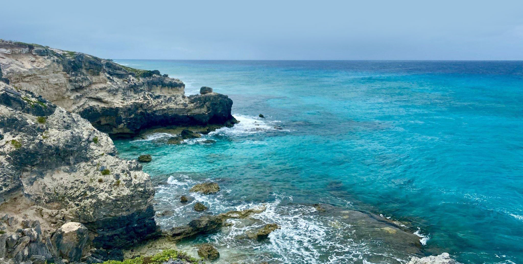 a rocky beach with blue water