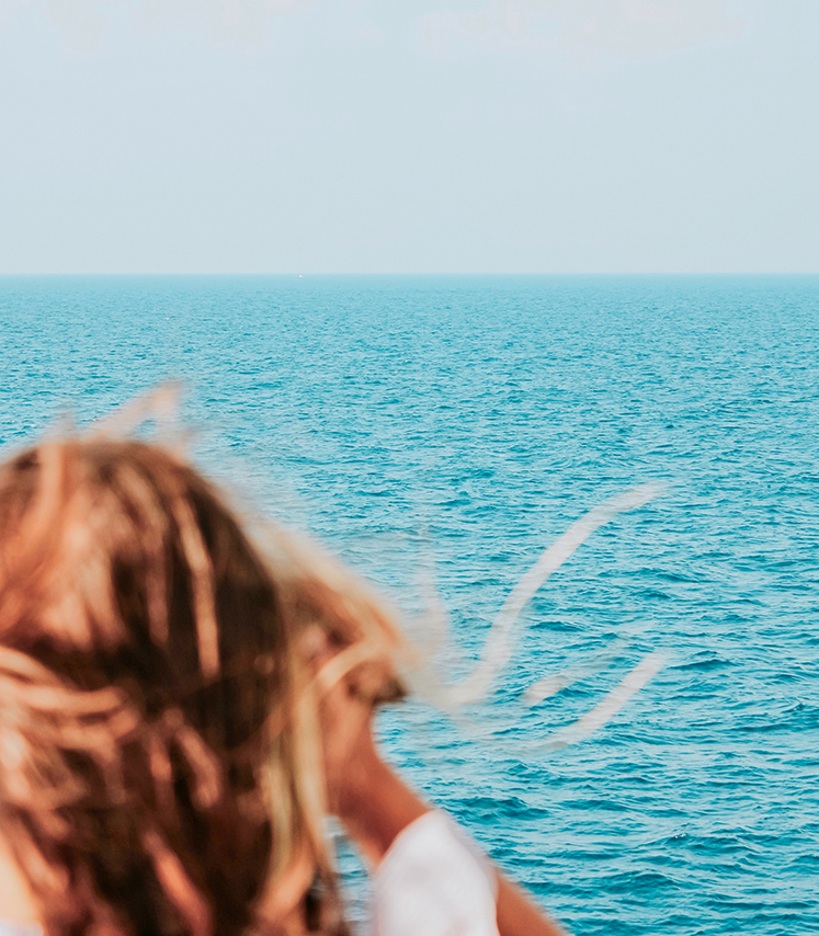 a person standing on a boat looking at the ocean