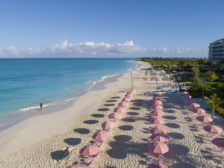 a beach with umbrellas and chairs