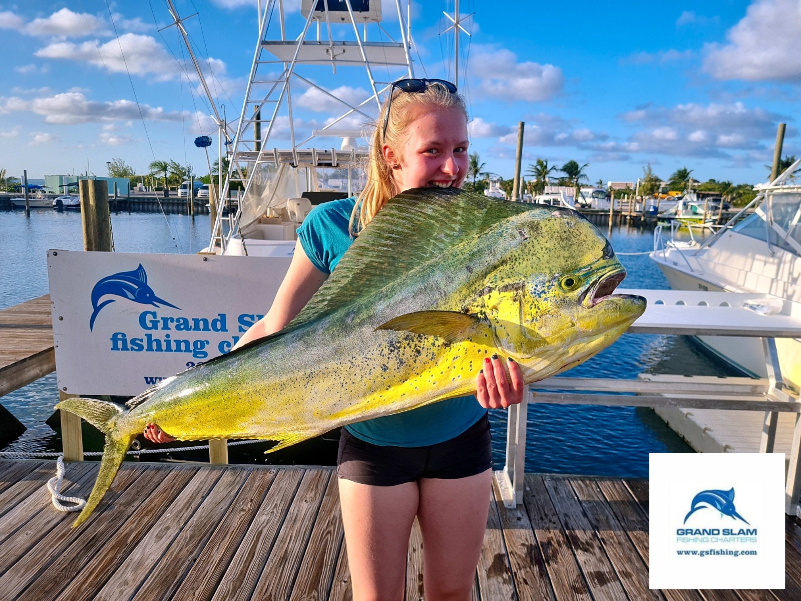 a girl holding a large fish
